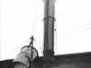 erection-of-new-metal-chimney-showing-section-hoisted-higher-with-1-worker-a