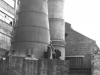 image-of-the-bases-of-two-chimneys-one-brick-one-metal-with-a-brick-base-with-4-workers