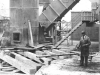 metal-chimney-base-with-worker-in-foreground-and-metal-steps-behind-worker