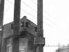 three-metal-chimneys-in-industrial-yard-with-2-workers-winding-a-winch