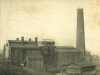 hexagonal-brick-chimney-with-4-workers-on-top-railway-and-factory-nearby-with-4-chimneys-on-factory